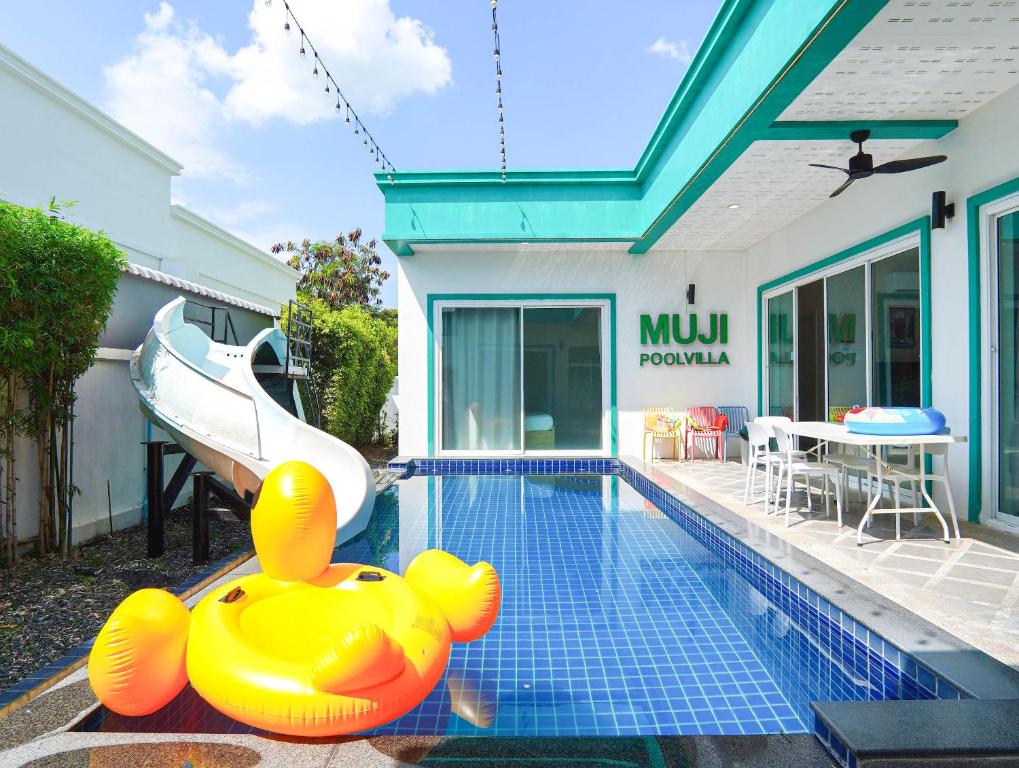 a pool with a rubber duck in the middle of a house at MUJI House Poolvilla Pattaya in Na Jomtien