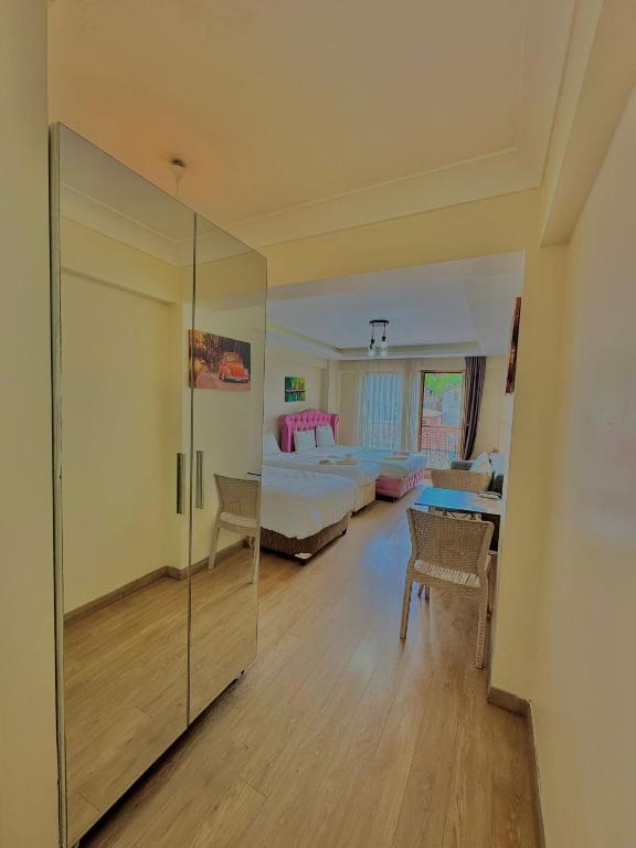 a bedroom with a bed and a room with a glass wall at Green Suite in Istanbul