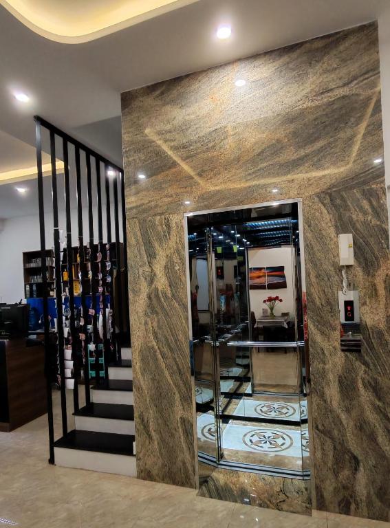 a lobby with a staircase and a room with wine bottles at The Star hotel DTH3-31 in Phú Quốc
