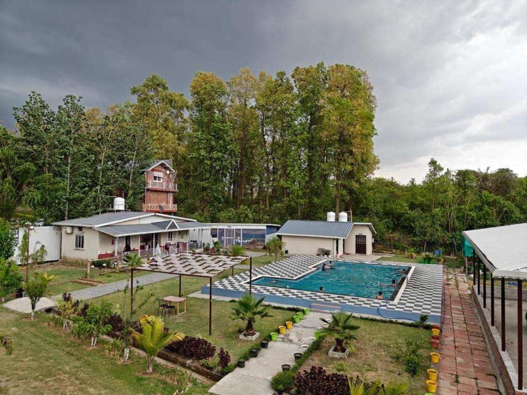 an aerial view of a house with a swimming pool at Nature Nest Farms in Chūharpur