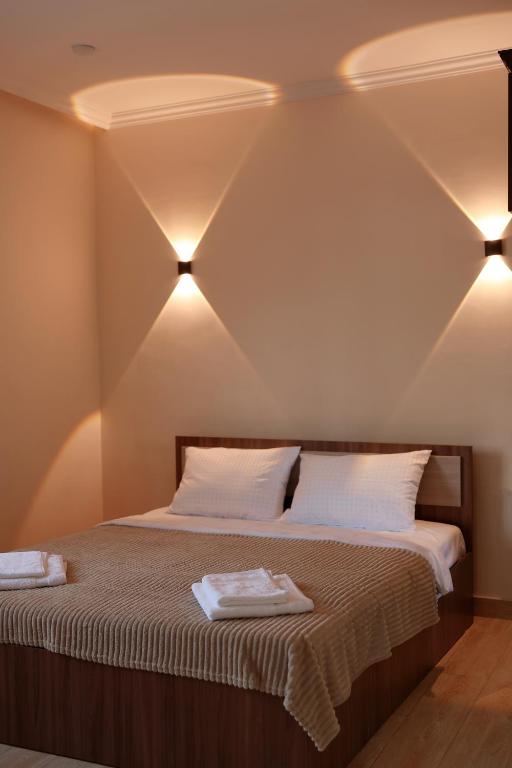 a bedroom with a bed with two towels on it at Airport Garden hotel in Pʼarakʼar