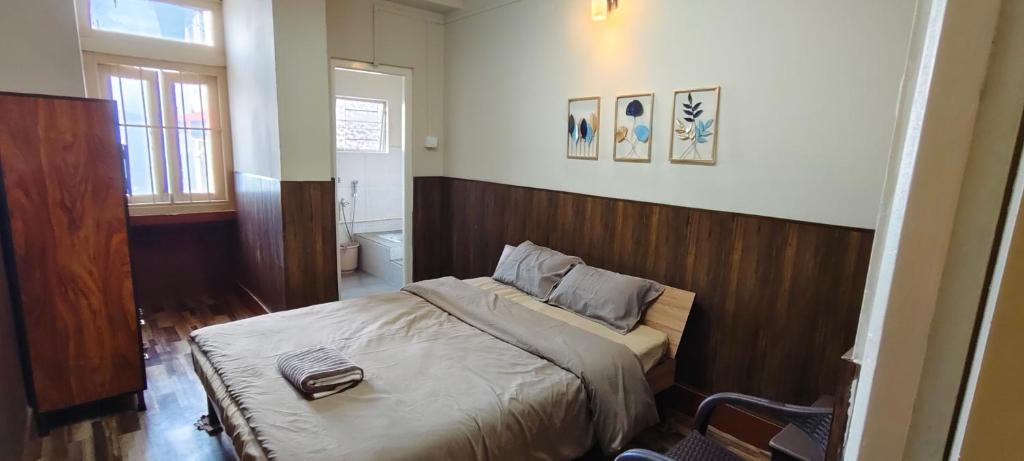 a bedroom with a large bed with a wooden headboard at Dreamstay lodge in Kohīma