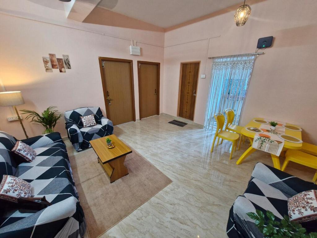 a living room with two couches and a table at Jorhat Homestay in Jorhat
