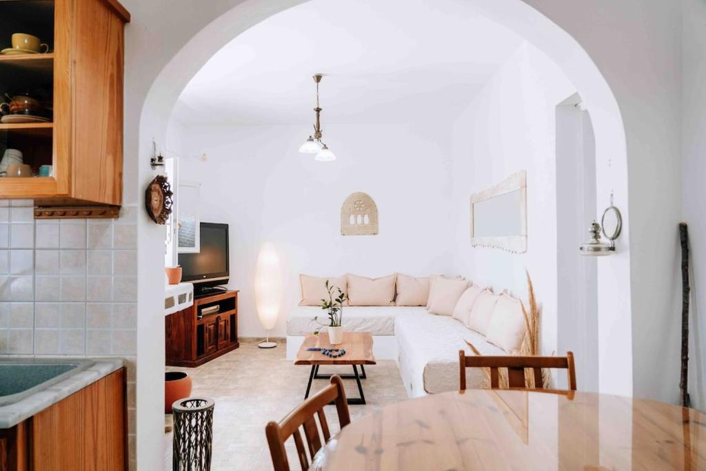 a living room with a couch and a table at Ormos Isternia House in Istérnia