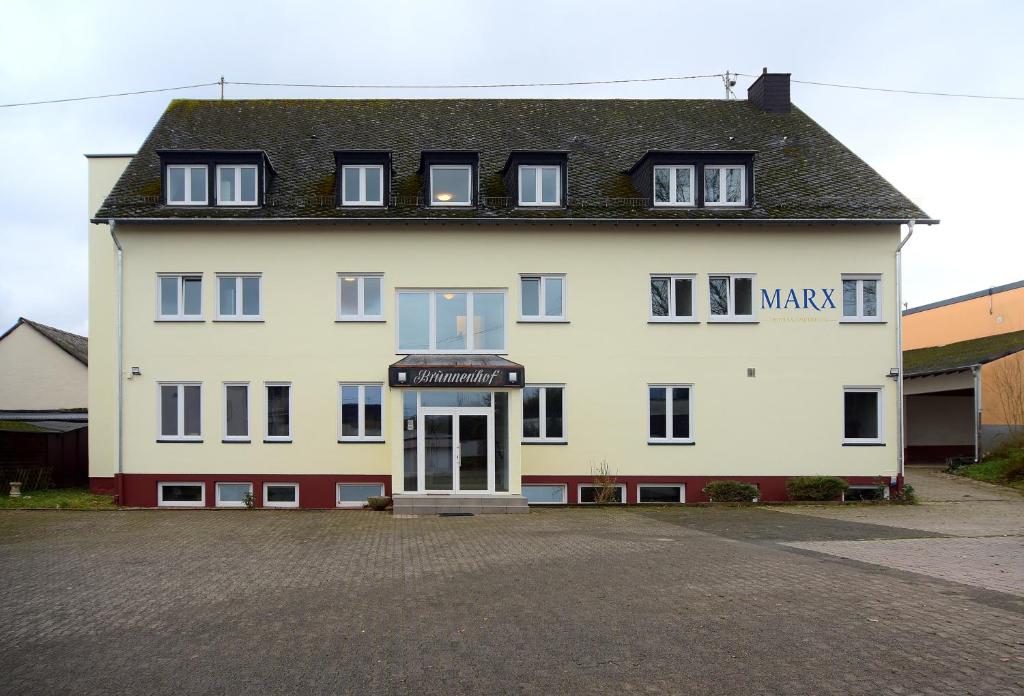 a large white building with a sign that reads mack maker at Brunnenhof - Serviced Apartments in Bekond