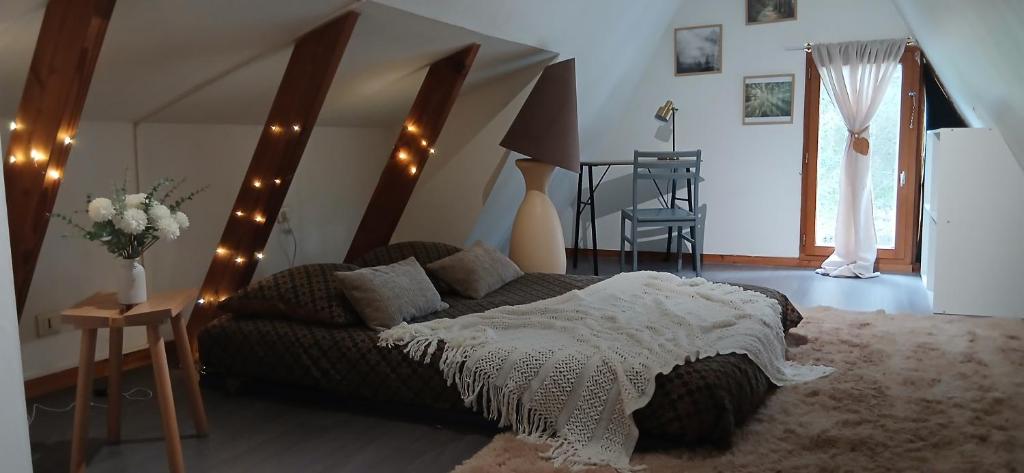 a bedroom with a bed and a staircase with lights at Mon petit chalet in Puycornet