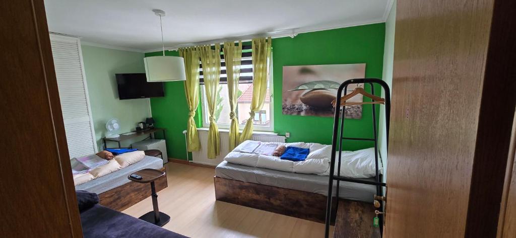 a living room with green walls and a bunk bed at Sonnige Ferienzimmer WHV in Wilhelmshaven