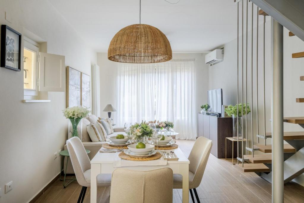 a dining room and living room with a table and chairs at The Crystal Vine Lounge in Montecarlo