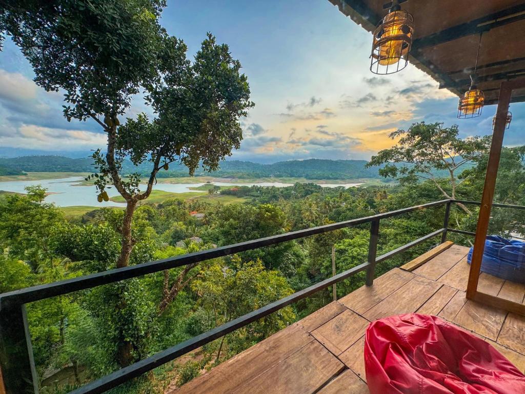 a balcony with a view of a river and trees at Victoria Sky Crest - Kandy in Teldeniya