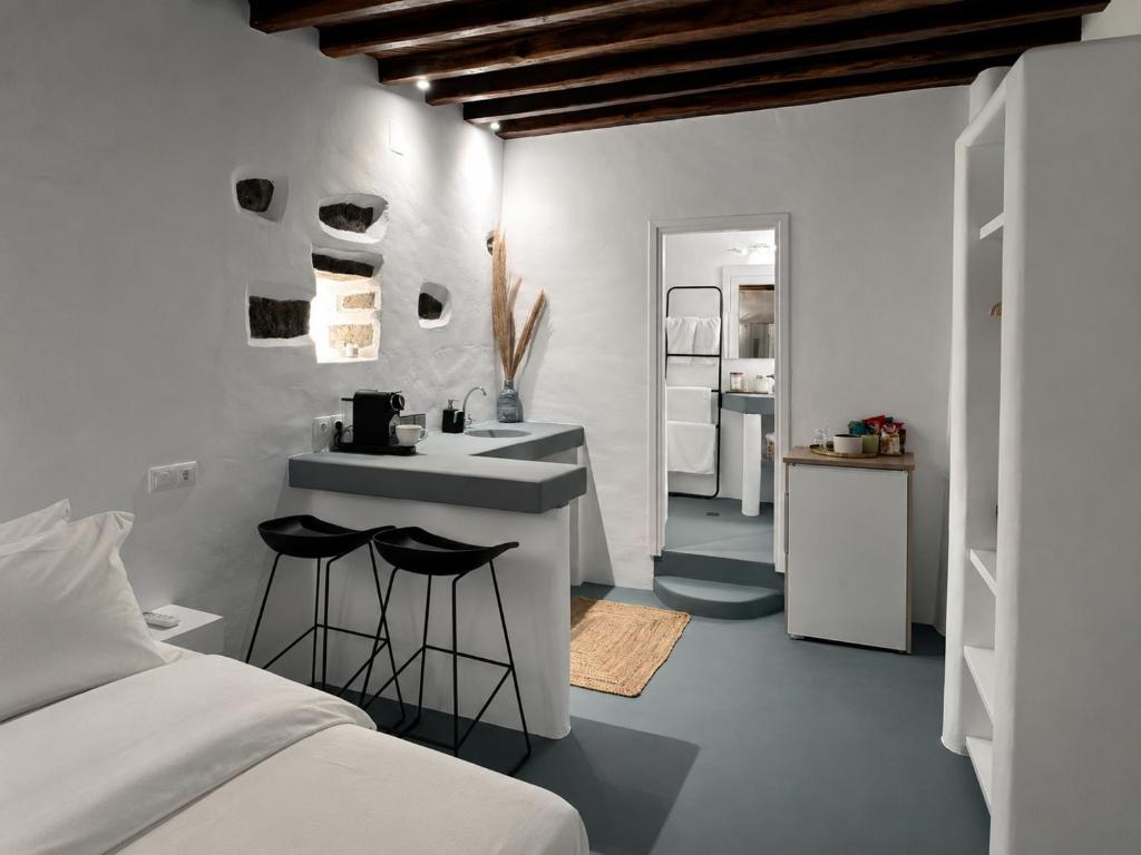 a bedroom with a bed and a sink and a counter at VR Chora Apartments in Serifos Chora
