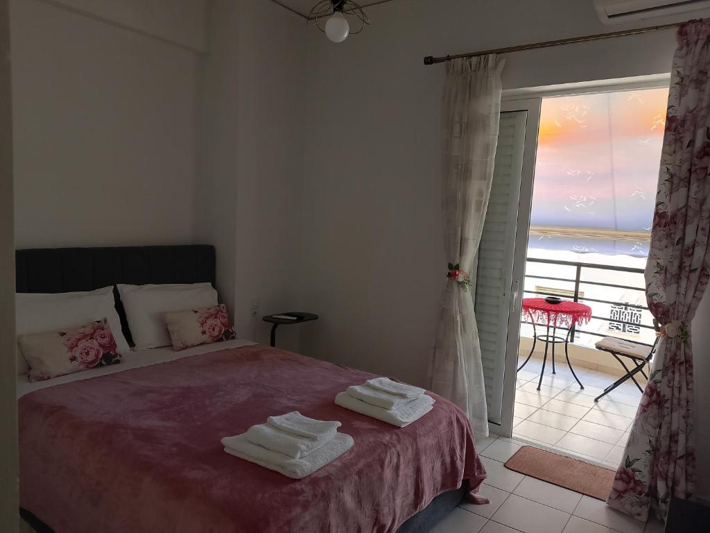 a bedroom with a bed with towels on it at Alkyona in Patra