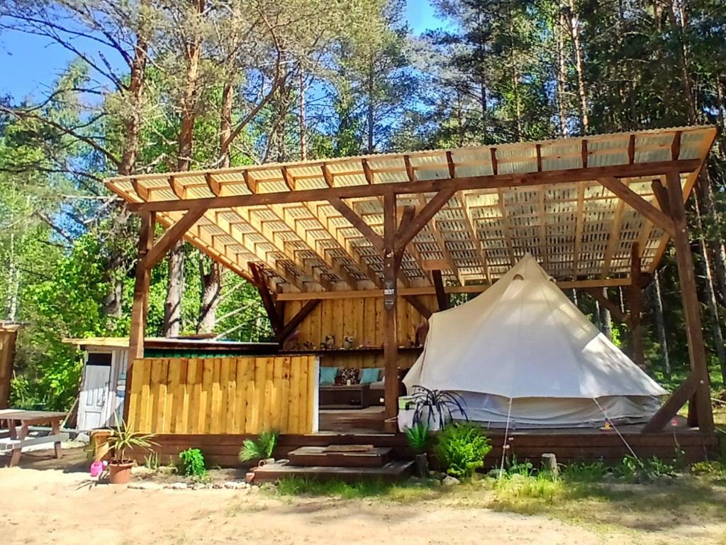 a gazebo with a tent under it at Miami Jungle Glamping Experience in Korjuse