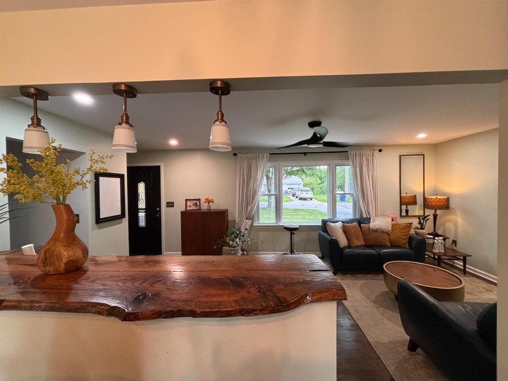 a living room with a table and a couch at Eclectic & Fun Custom Home in Shawnee