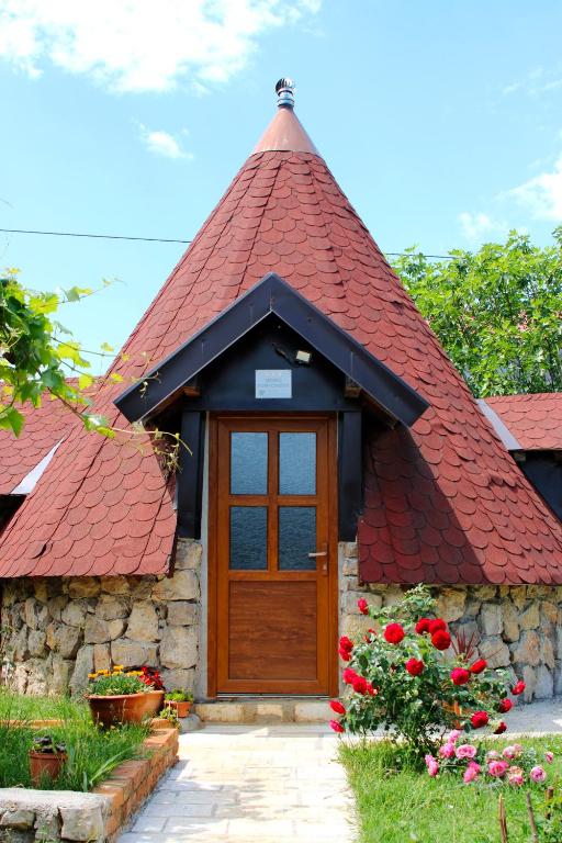 a small house with a red roof at Seosko domaćinstvo Peković in Danilovgrad