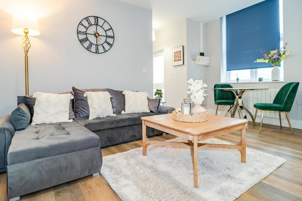 a living room with a couch and a table at Gabriel's Gaff in Maidstone
