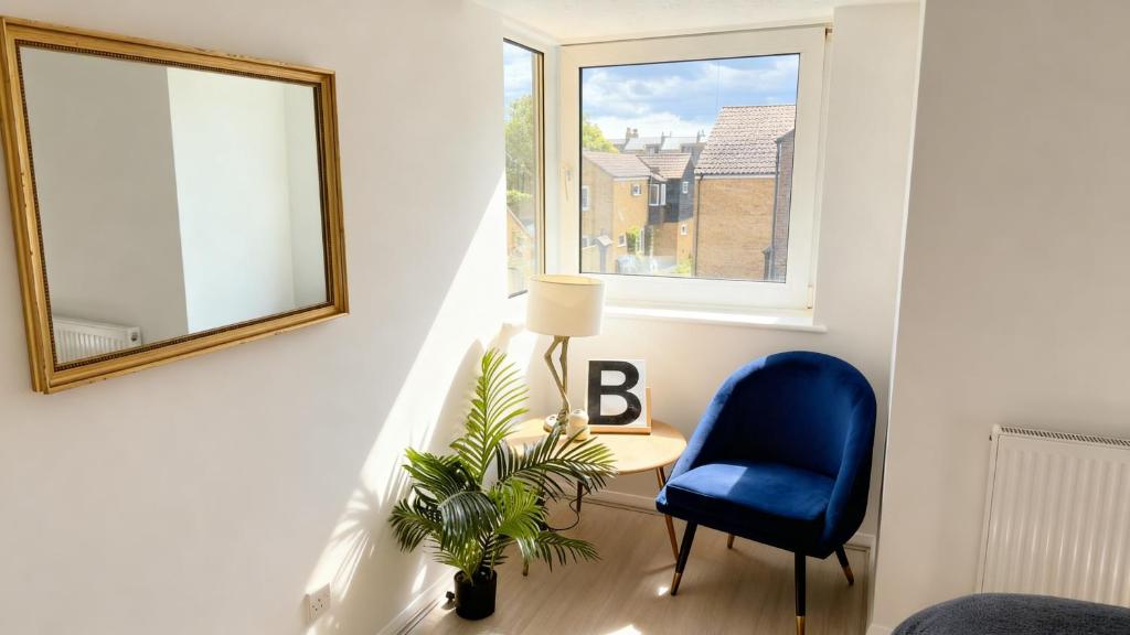 a room with a blue chair and a table and a window at Modern 2-Bed Apartment in Ramsgate in Ramsgate