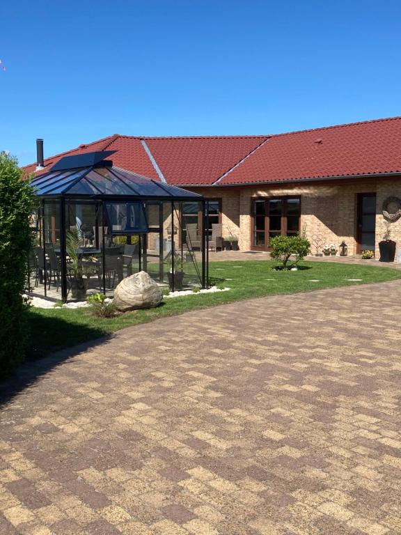 a building with a pavilion with a playground in front of it at Driverhuset B&B in Grindsted