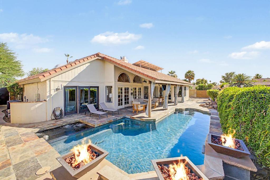 a house with a swimming pool with fireplaces at NEW Royal Palms Retreat with Pool Spa & Pool Table in Tempe