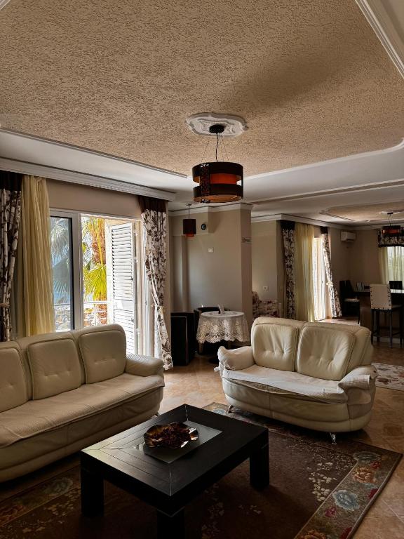 a living room with two couches and a table at Apartment in Durres Elio in Golem