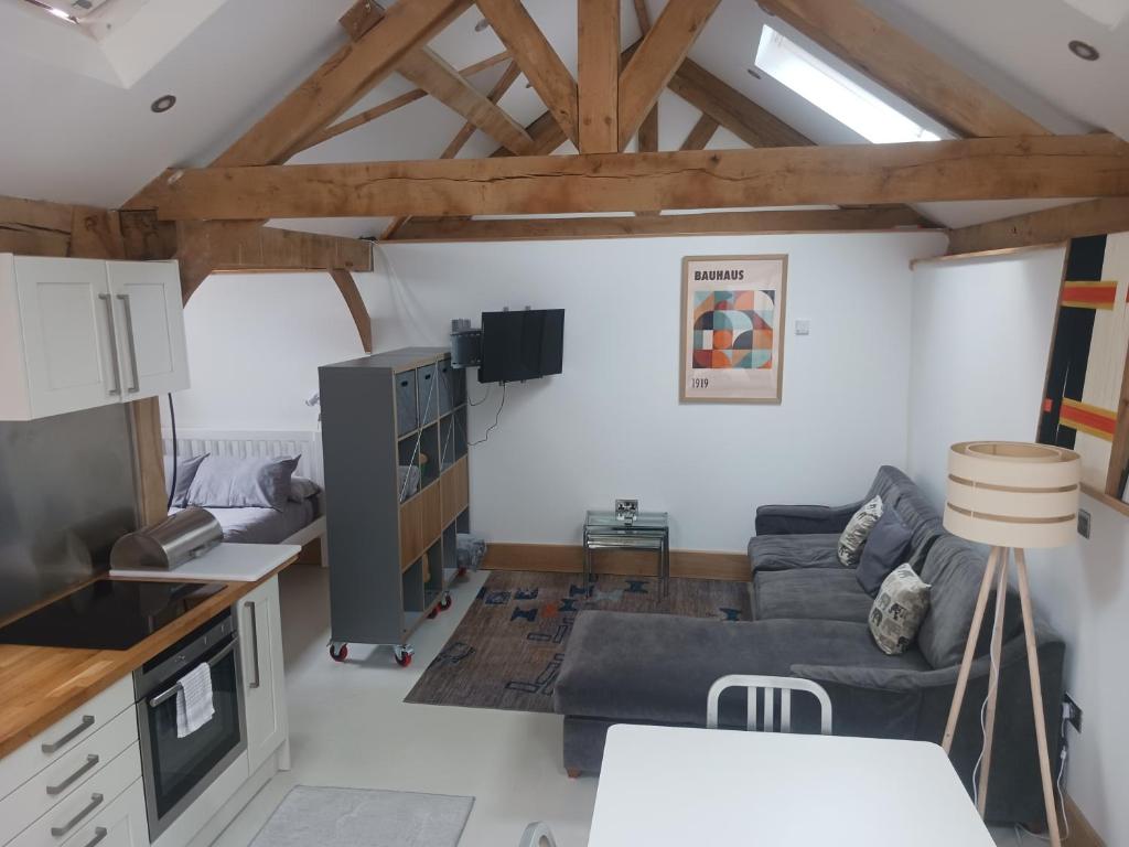 a living room with a couch and a table at Oak framed appartment in Chester