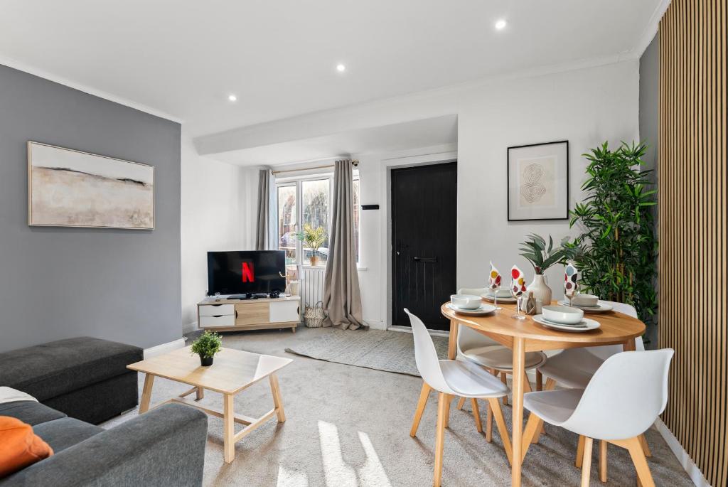 a living room with a couch and a table at Spacious Modern 2BR - Parking - Workspace Area, Ideal for Contractors & Long Stays - NordStay in Amley