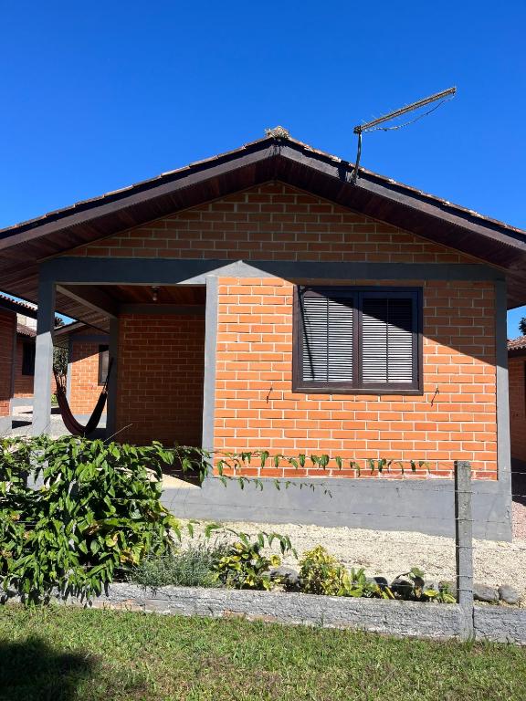a brick house with a window and some plants at Bella Vite in São José dos Pinhais