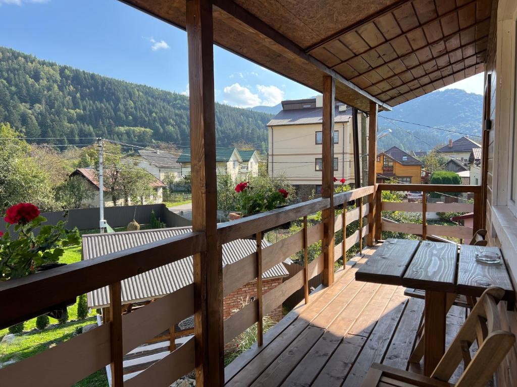a balcony with a table and a view of the mountains at Welcome to Карпати in Skole