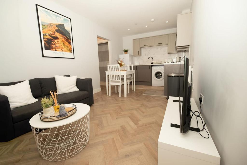 a living room with a couch and a table at The Loft Town Centre in Merthyr Tydfil