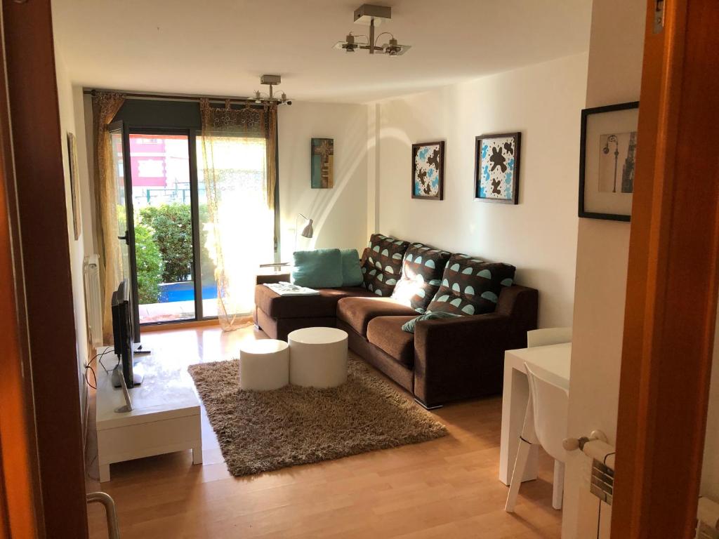 a living room with a couch and a rug at Bajo con jardín in Miengo
