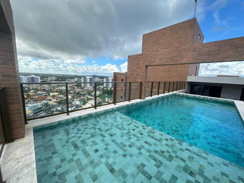 a swimming pool on the roof of a building at View Soft House Apto 1007 in Lauro de Freitas