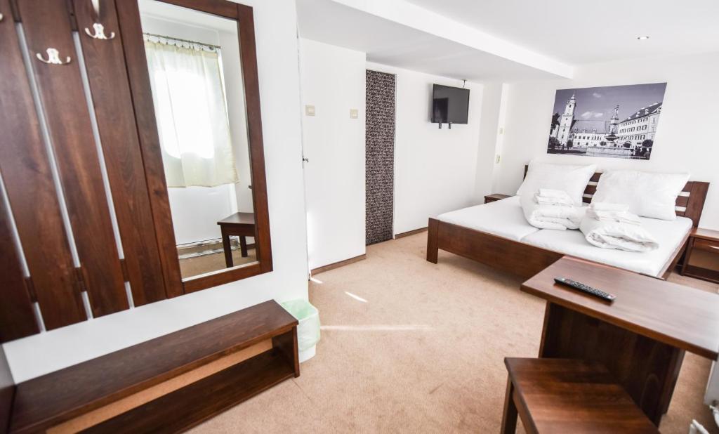 a living room with a couch and a mirror at Botel Gracia in Bratislava