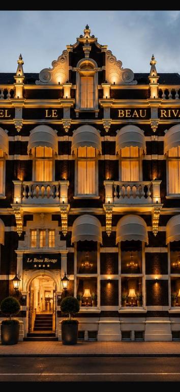 a large building with lights on the front of it at Hotel Le Beau Rivage in Middelburg