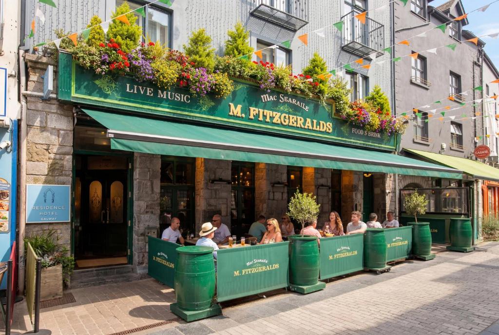 a group of people sitting at a restaurant at The Residence Hotel in Galway