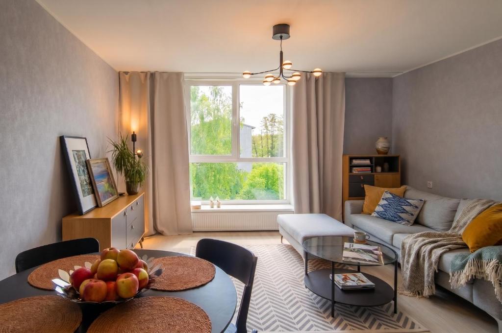 a living room with a couch and a table at Hiiu korter Kärdlas in Kärdla