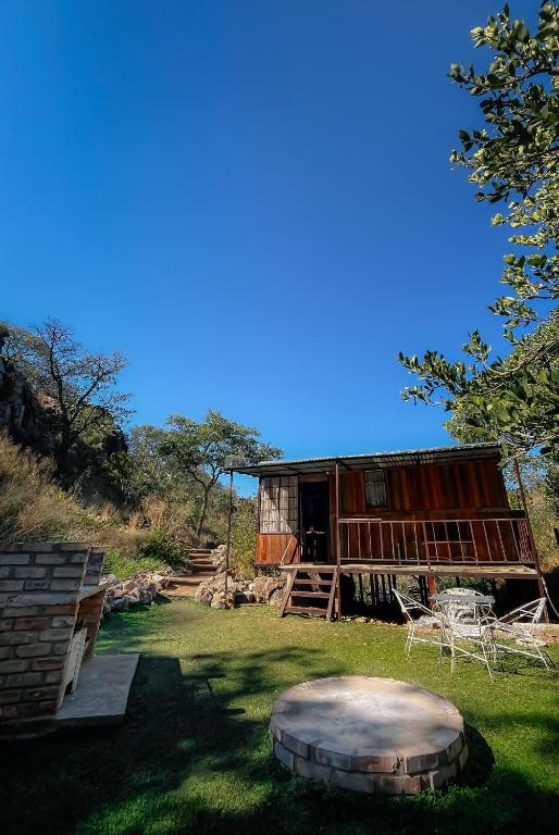 a building with a dome in the grass next to it at Glocke Mountain Camp, Cabin in Outjo