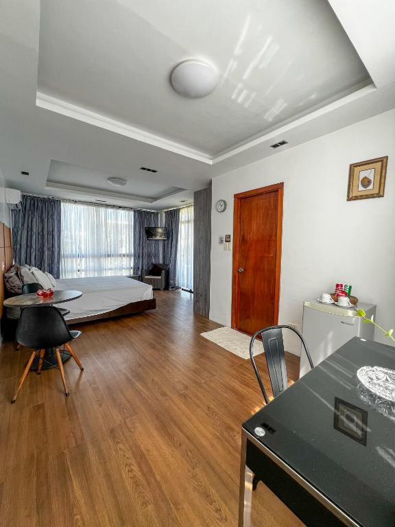 a living room with a bed and a table at The Hermitage Tagaytay-Presidential Suite in Malabag