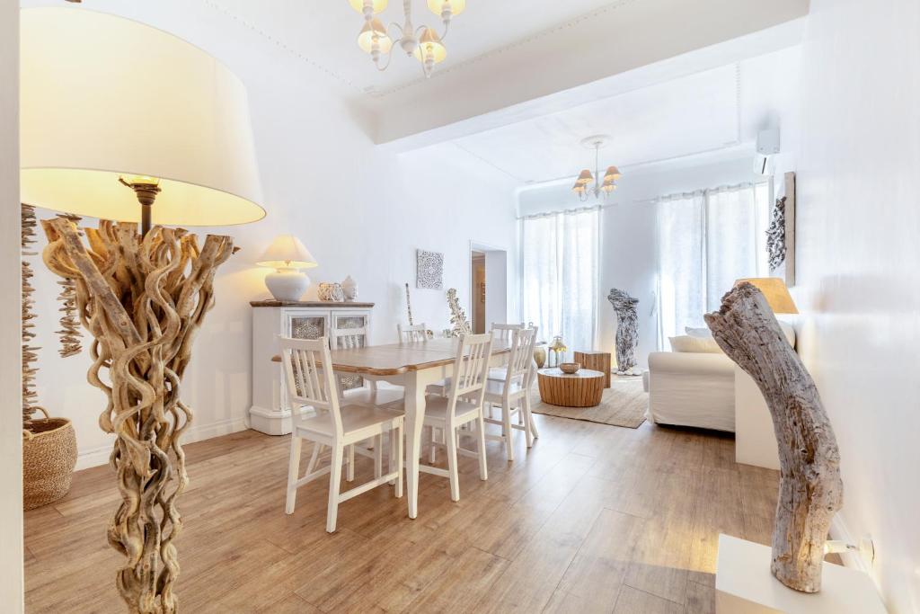 a dining room and living room with a table and chairs at Piazza di Spagna Historic Flat in Rome