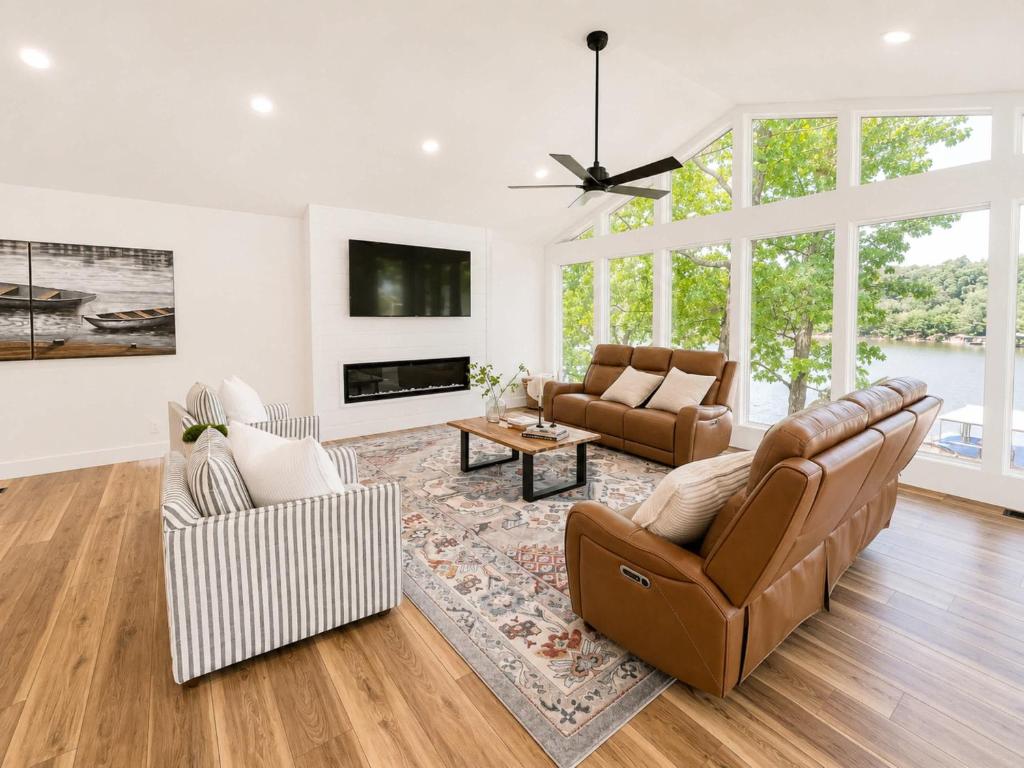a living room with two couches and a tv at The Ozark Acre 6BDR Lakefront in Sunrise Beach