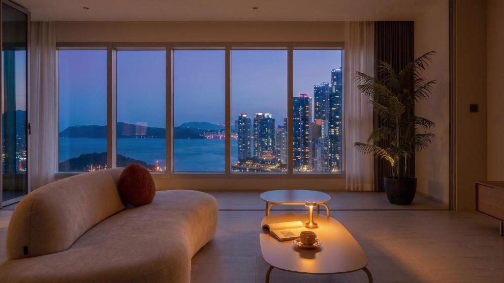 a living room with a couch and a large window at Le Collective Haeundae Paragraf in Busan