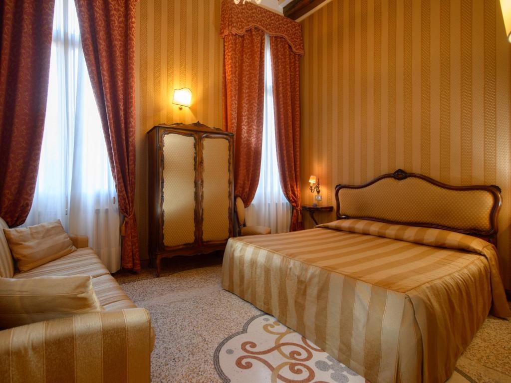 Postel nebo postele na pokoji v ubytování Centauro Hotel