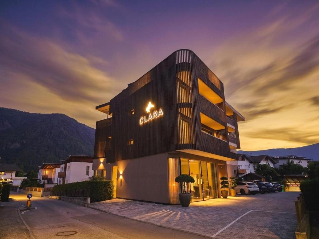 a building with a sign on the side of it at B&B Boutiquehotel Clara in Brunico