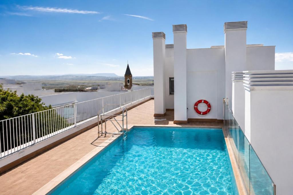 a swimming pool on the balcony of a house at NUEVO-LUZ DE CONIL piscina y parking in Conil de la Frontera