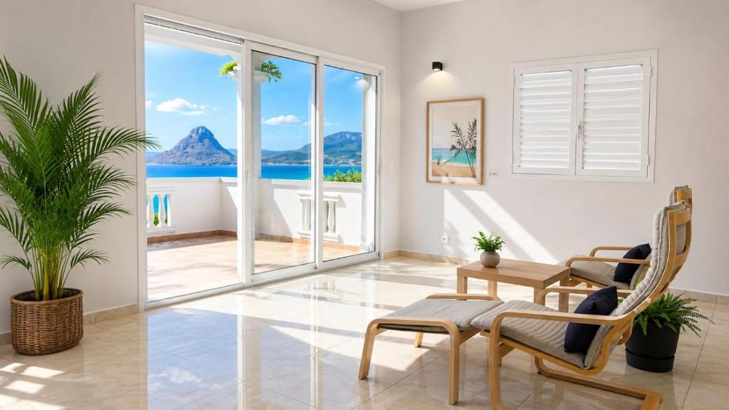 a living room with a view of the ocean at Villa de détente "Tombosoa" avec vue sur la baie de Diego-Suarez in Antsiranana