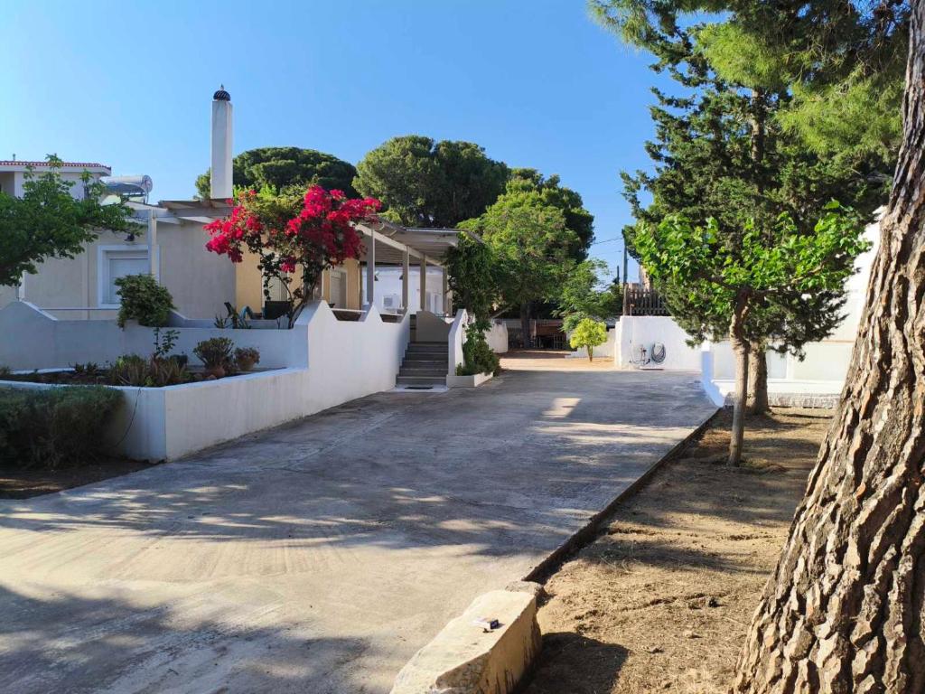 a street with a house and a tree at Nicks house by zarkco in Artemida