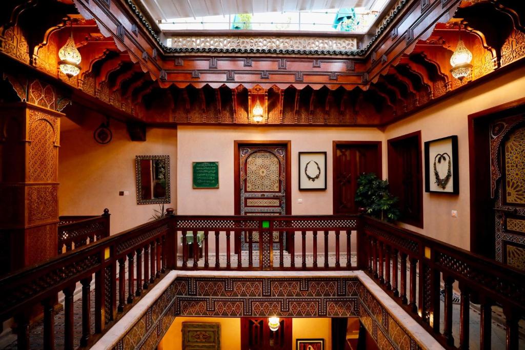 an ornate staircase in a building with a ceiling at Riad Jamaique - Marrakech in Marrakesh