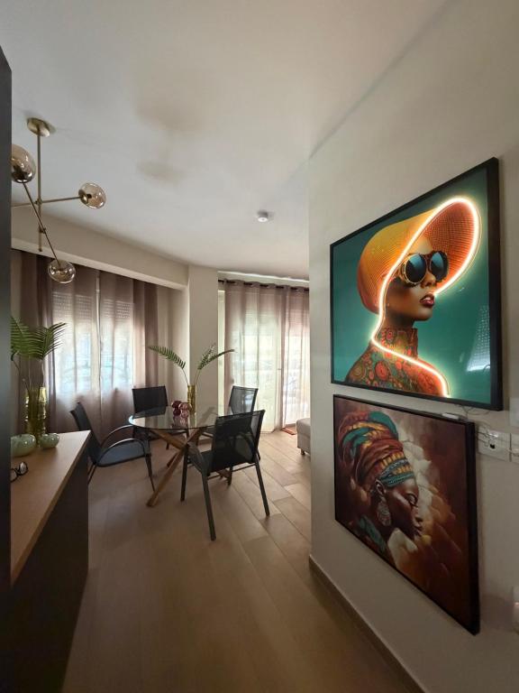 a living room with a flat screen tv on a wall at DD apartments & suites in Paralia Katerinis