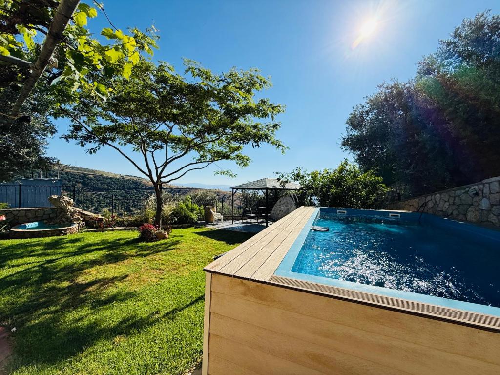 a swimming pool in the yard of a house at The Sky Zimmer in Ein Kinya