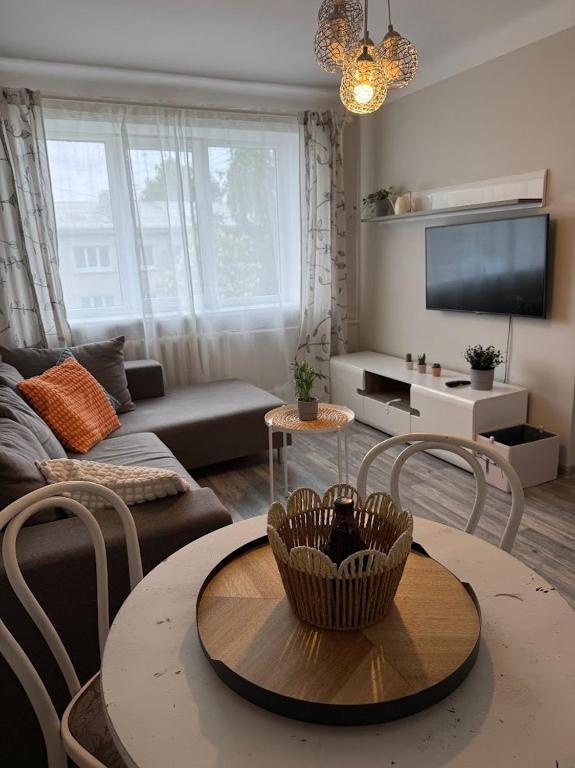 a living room with a couch and a table and chairs at Gallo Riga Apartments in Riga