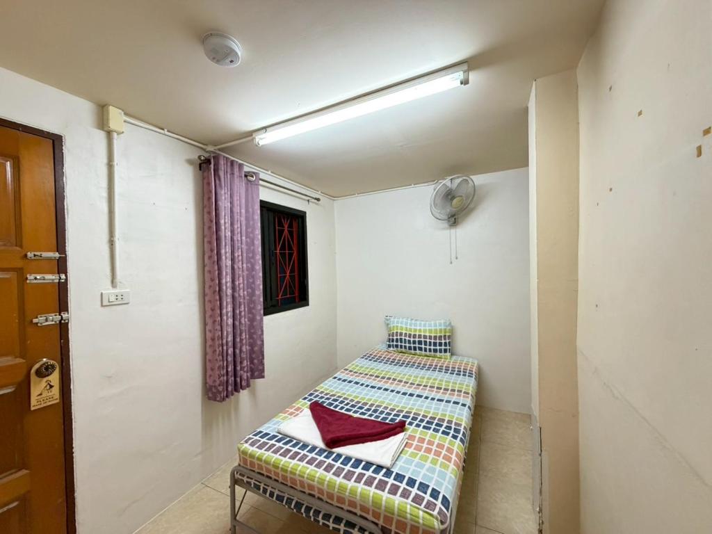 a room with a couch in the corner of a room at J Home in Ao Nang Beach