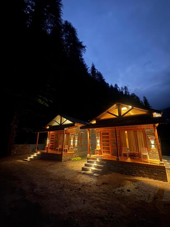 a building at night with the lights on at The Pravaas Resort in Barot 
